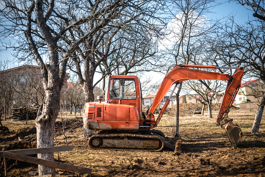 track-type excavator loader and backhoe working on earth