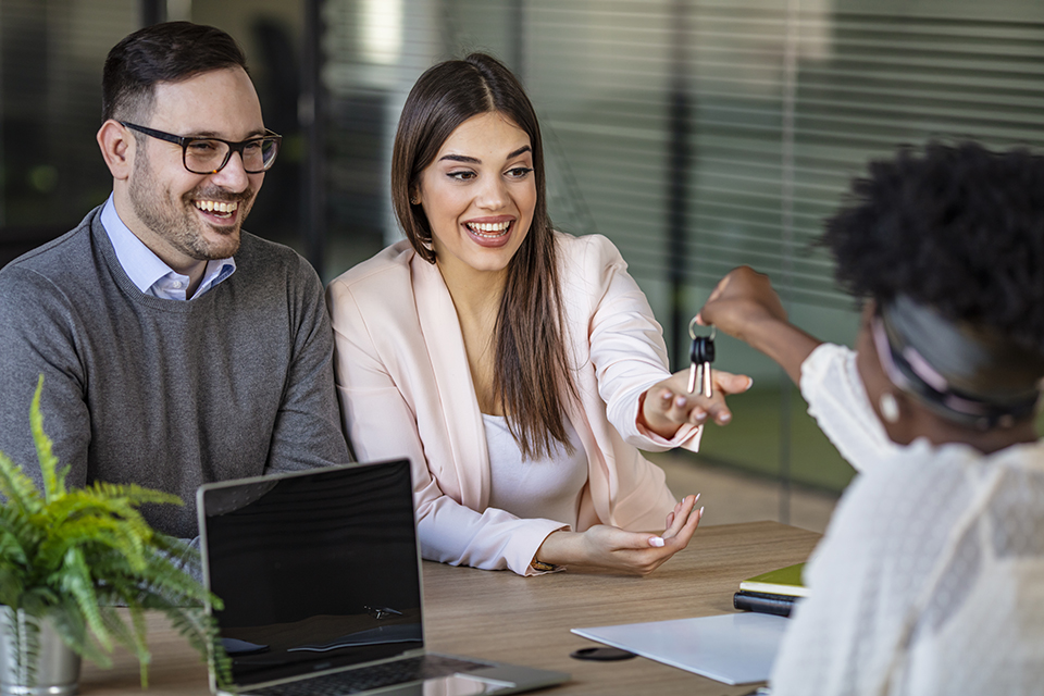 Real estate agent having a meeting with young couple